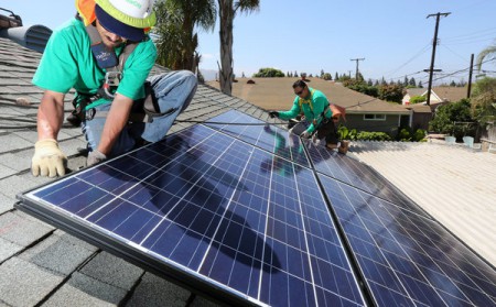 Workers for SolarCity installing solar panels (Image: JE Flores/NYTimes)