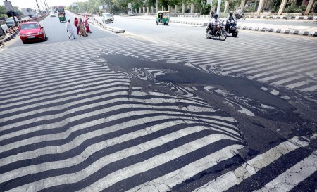 In India last May, temperatures rose to 120°F (50°C), killing more than 2,300 people—and melting this street in New Delhi (Image: H. Tyagi/EPA)