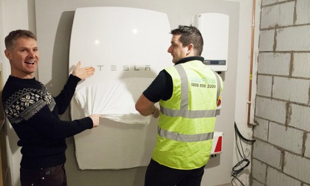 A SolarPlant engineer installs the UK’s first Powerwall home battery in Cardiff at Mark Keer and Lyndsey Bennett’s home (Image: G. Phillips/Guardian)