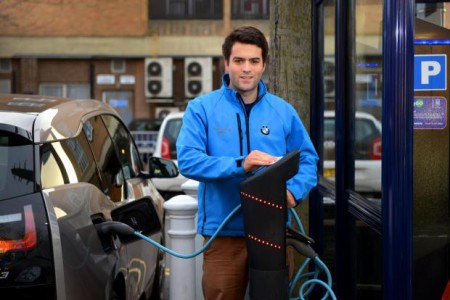 James Brown, from BMW I sales, with a BMW i3 electric car at a charging point at the Tesco car park off Cowley Road