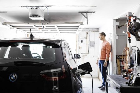 Eric Brassard charges his new BMW i3 electric car in his garage (Image:: J. Schmelzer/WSJ)