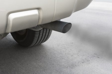 32011833 - a car emits carbon monoxide gas from its exhaust tailpipe, showing how pollution is formed.