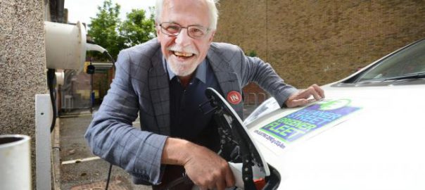 Oxford city councillor John Tanner plugging a charger into one of the council's own vehicles